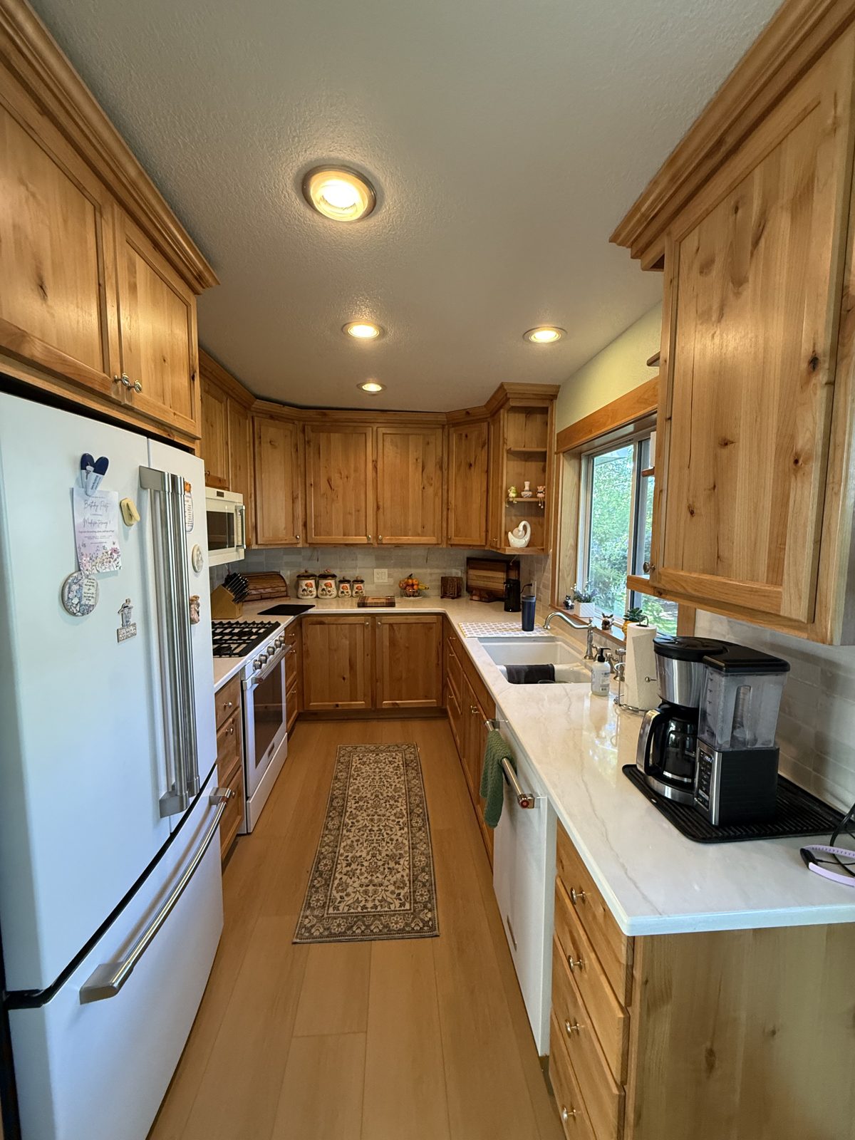 Completed kitchen remodel with new cabinetry, counters, and lighting